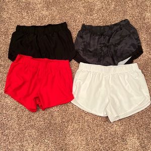 Four pair of women’s athletic works size large 12 to 14 shorts